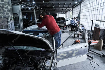 car-service-worker-repairs-restores-car_154092-15010